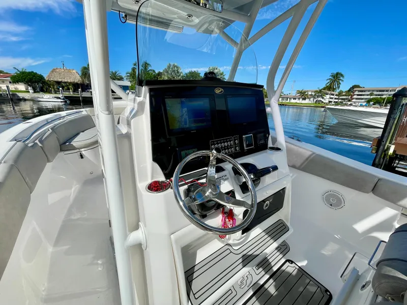 Slide: The Image of 2019 Sea Fox 288 Commander boat cockpit with steering wheel and navigation screens. - 19