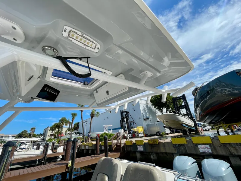 Slide: The Image of 2019 Sea Fox 288 Commander boat at dock, showcasing overhead features and clear sky. - 20