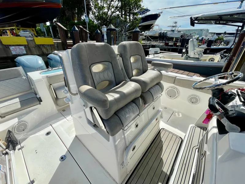 Slide: The Image of 2019 Sea Fox 288 Commander boat interior with dual cushioned seats and steering wheel. - 22