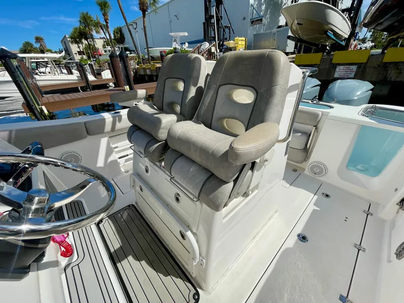 Slide: The Image of 2019 Sea Fox 288 Commander boat interior with dual cushioned seats and steering wheel. - 23
