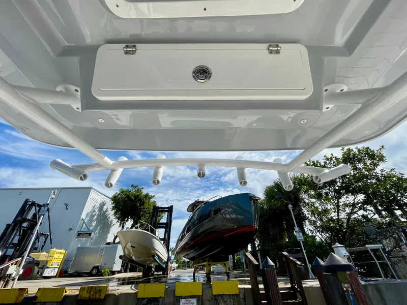 Slide: The Image of 2019 Sea Fox 288 Commander boat in a marina, viewed from below, with clear sky. - 24