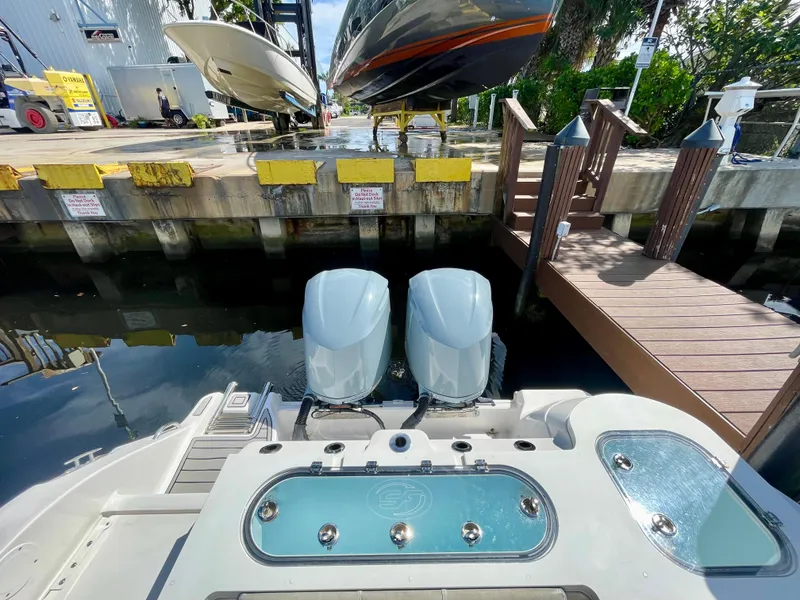 Slide: The Image of 2019 Sea Fox 288 Commander with dual engines docked near a marina. - 31