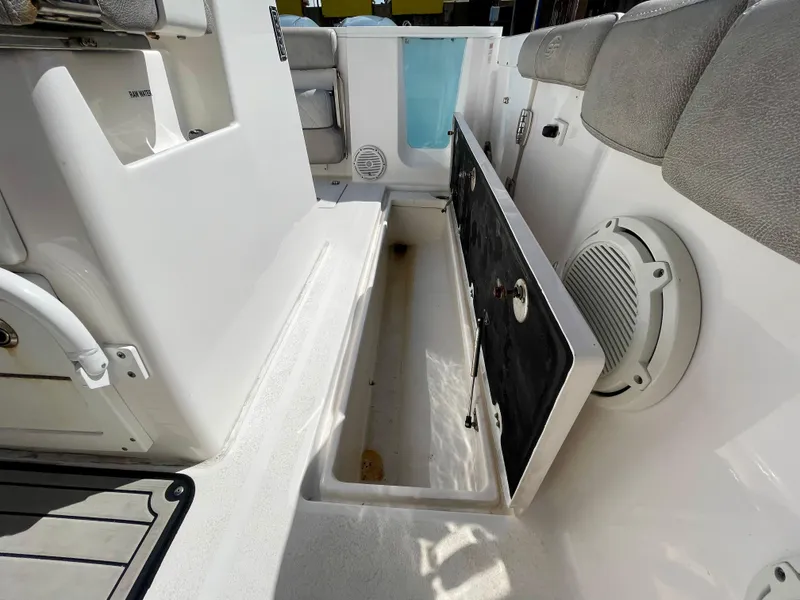 Slide: The Image of 2019 Sea Fox 288 Commander boat interior with open storage compartment and seating. - 36