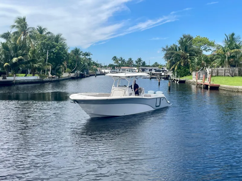 Slide: The Image of 2019 Sea Fox 288 Commander boat cruising on a scenic waterway with palm trees. - 37