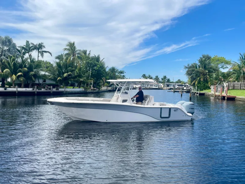 Slide: The Image of 2019 Sea Fox 288 Commander boat cruising on a calm, scenic waterway. - 38