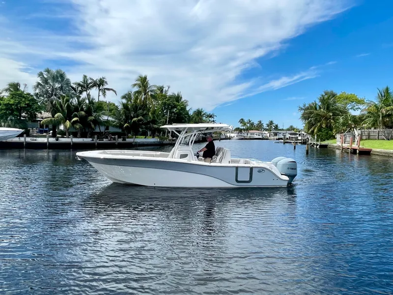 Slide: The Image of 2019 Sea Fox 288 Commander boat cruising on a calm waterway with palm trees. - 39