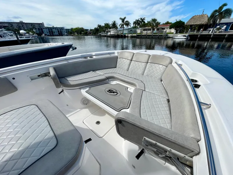Slide: The Image of 2019 Sea Fox 288 Commander boat with spacious seating, docked in a scenic marina. - 5
