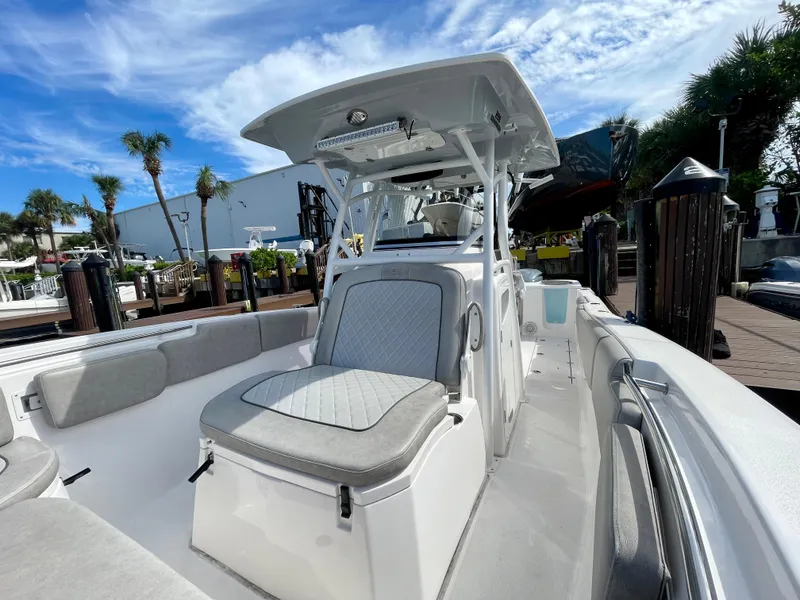 Slide: The Image of 2019 Sea Fox 288 Commander boat with seating, docked under a clear blue sky. - 7