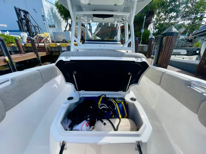 Slide: The Image of 2019 Sea Fox 288 Commander boat with open storage compartment, docked at marina. - 9