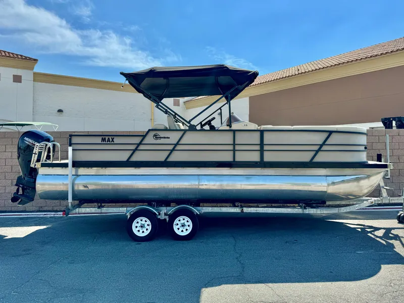 The Image of 2023 Massimo Marine P23 MAX pontoon boat on trailer, parked outdoors. - 0