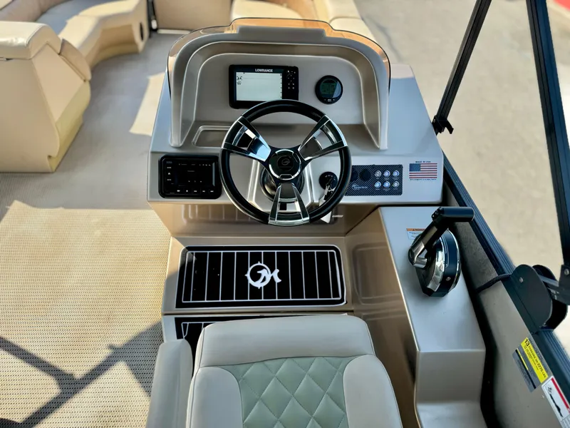 Slide: The Image of 2023 Massimo Marine P23 MAX boat dashboard with steering wheel and control panel. - 14