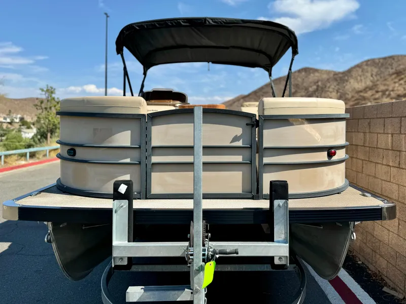 Slide: The Image of 2023 Massimo Marine P23 MAX pontoon boat on trailer, rear view. - 2