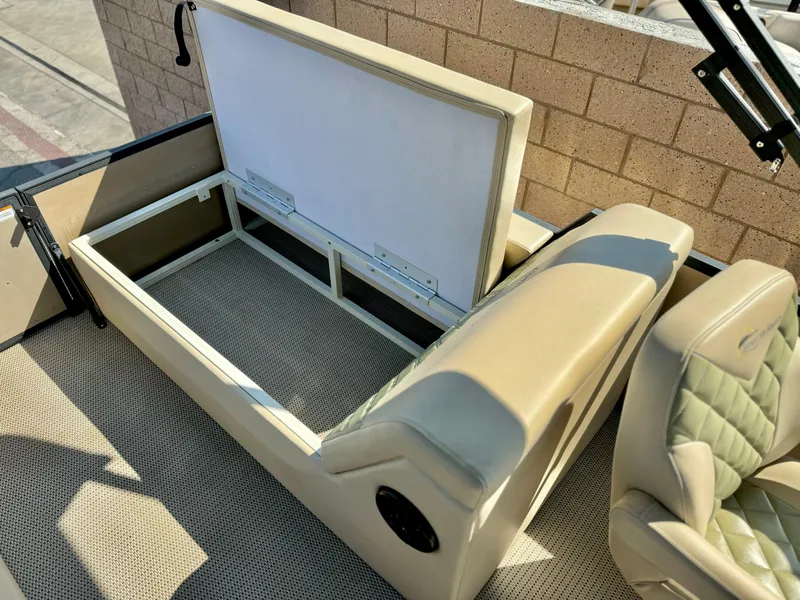 Slide: The Image of 2023 Massimo Marine P23 MAX boat interior with open storage compartment and beige seating. - 22