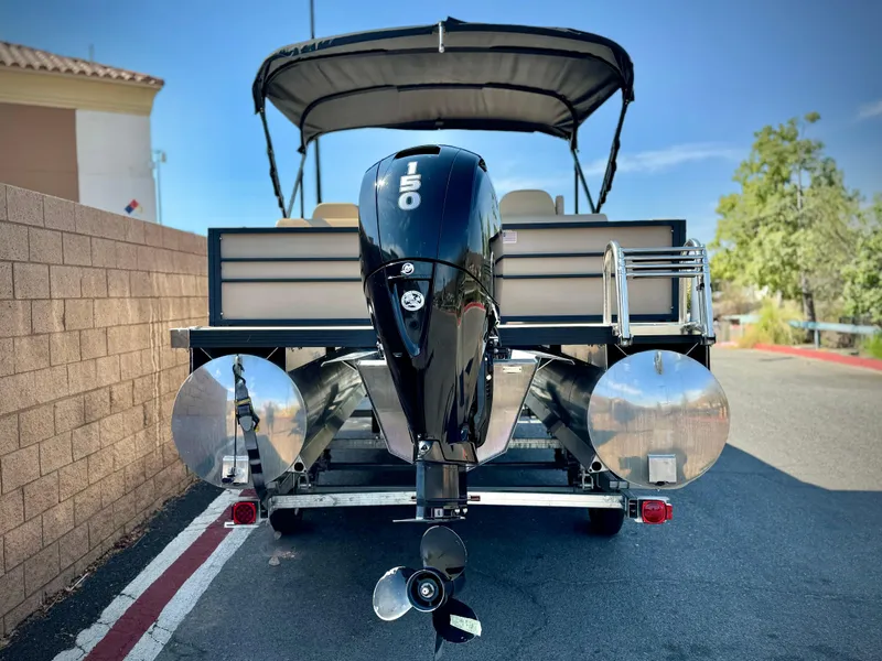 Slide: The Image of 2023 Massimo Marine P23 MAX boat with outboard motor, parked on a sunny day. - 4