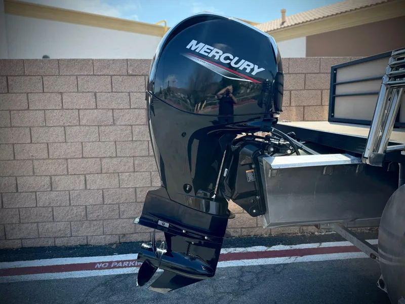 Slide: The Image of Mercury outboard motor on 2023 Massimo Marine P23 MAX boat, parked outdoors. - 6