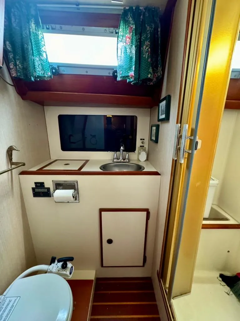 Slide: The Image of 1982 Pearson Ketch bathroom with sink, toilet, and shower. - 27