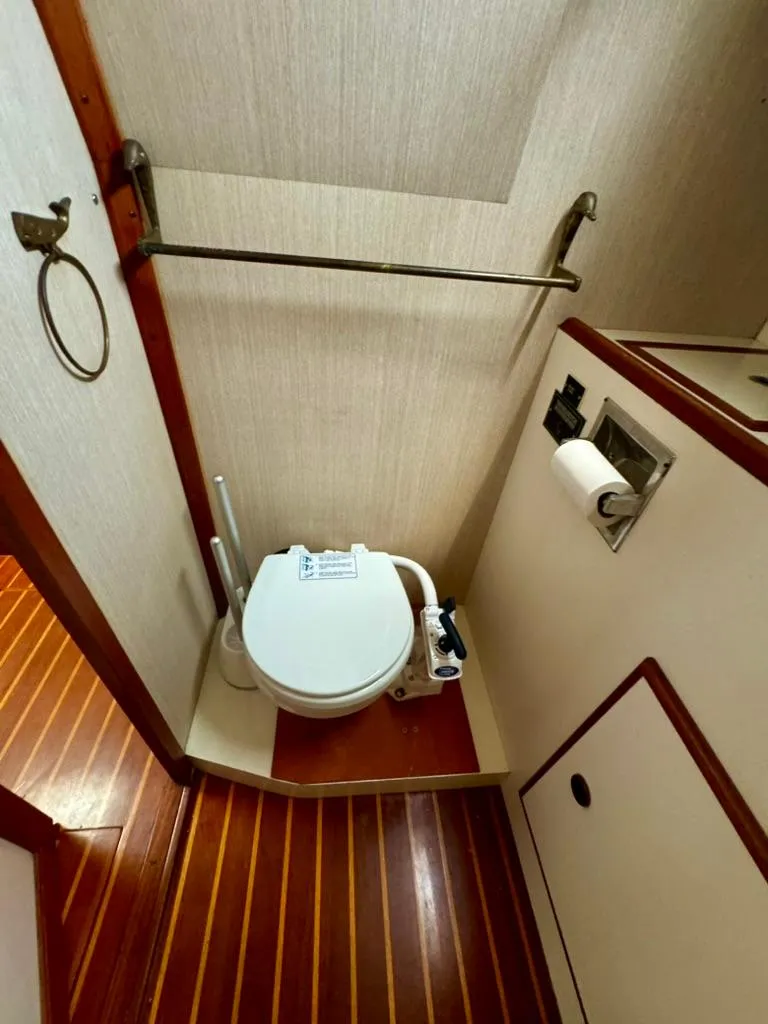 Slide: The Image of 1982 Pearson Ketch boat bathroom with wooden flooring and compact toilet. - 28