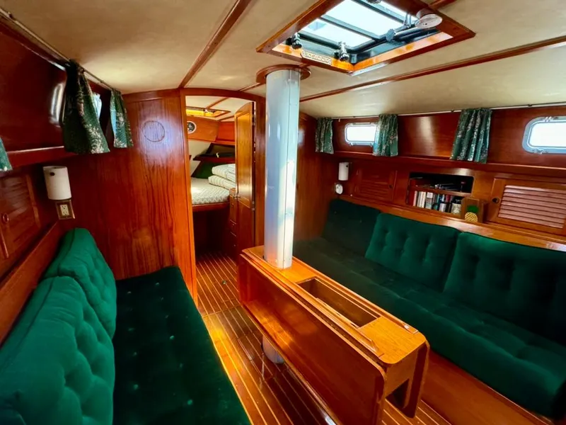 Slide: The Image of Interior of 1982 Pearson Ketch sailboat with green upholstery and wooden finishes. - 31