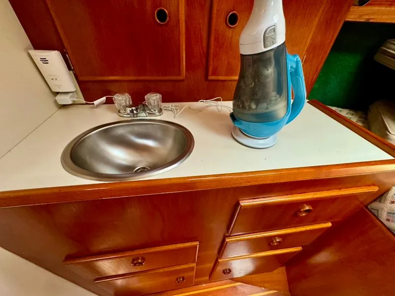 Slide: The Image of Wooden cabinet with sink and appliance in 1982 Pearson Ketch boat interior. - 38