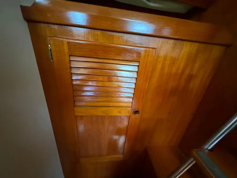 Slide: The Image of Wooden interior of 1982 Pearson Ketch sailboat, featuring a louvered cabinet door. - 41
