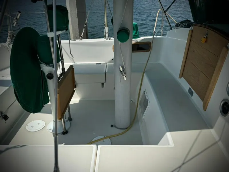 Slide: The Image of 1982 Pearson Ketch sailboat cockpit with seating and wooden accents. - 7