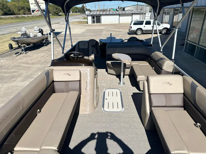 Slide: The Image of 2025 Bennington 22 SXS APG pontoon boat interior with seating and canopy. - 7