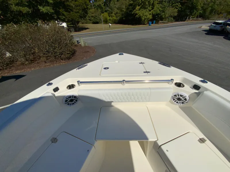 Slide: The Image of 2025 Cobia 240 Center Console boat, spacious deck view, parked outdoors. - 11