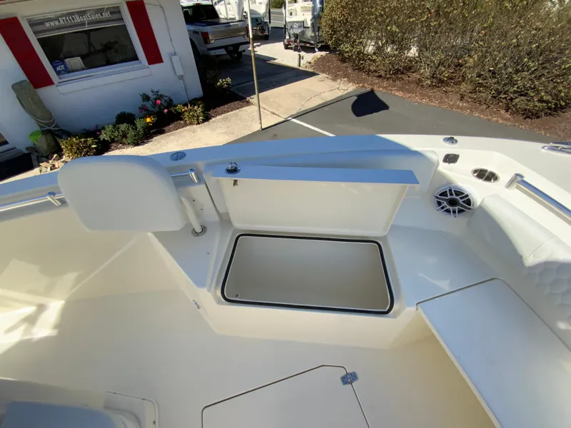 Slide: The Image of 2025 Cobia 240 Center Console boat interior with storage compartment and seating. - 17