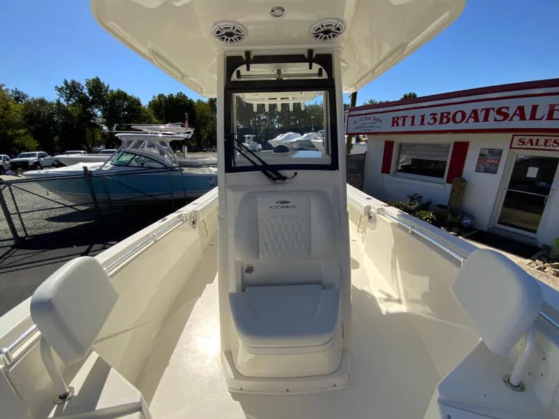 Slide: The Image of 2025 Cobia 240 Center Console boat at dealership, featuring spacious seating and modern design. - 19