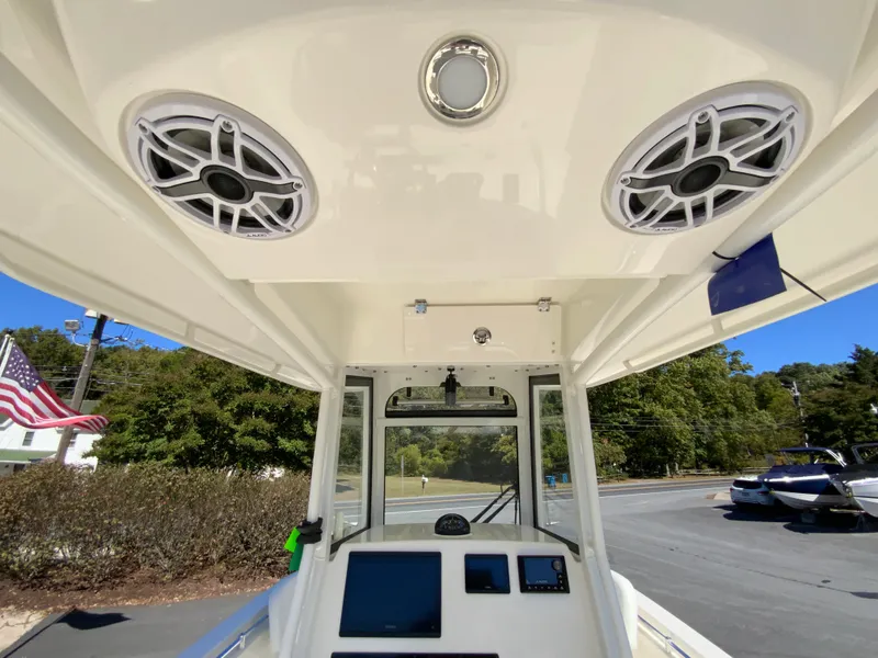 Slide: The Image of 2025 Cobia 240 Center Console boat interior with speakers and navigation equipment. - 22