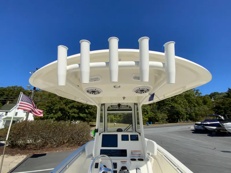 Slide: The Image of 2025 Cobia 240 Center Console boat with rod holders and navigation equipment. - 23