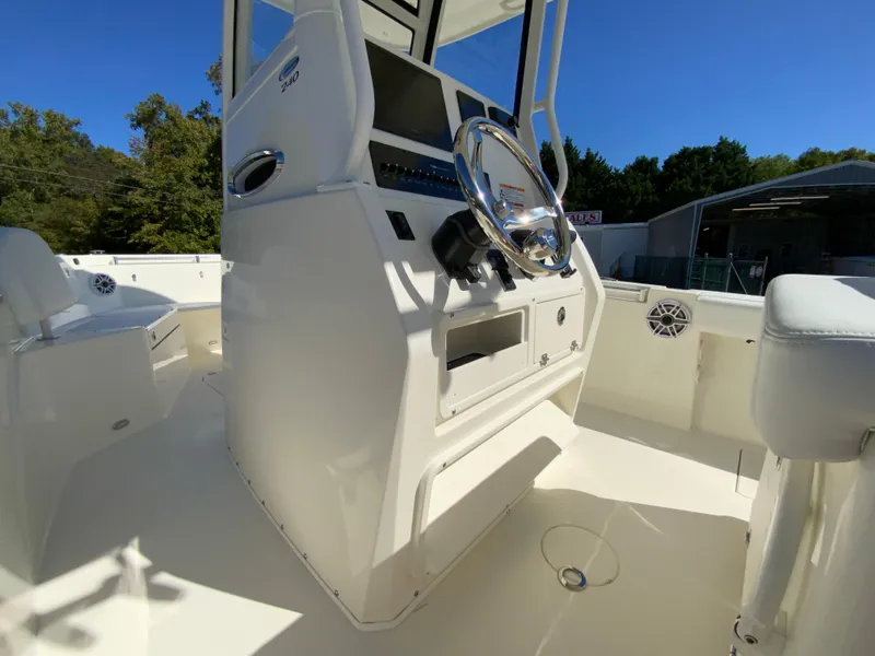 Slide: The Image of 2025 Cobia 240 Center Console boat interior with steering wheel and console. - 24