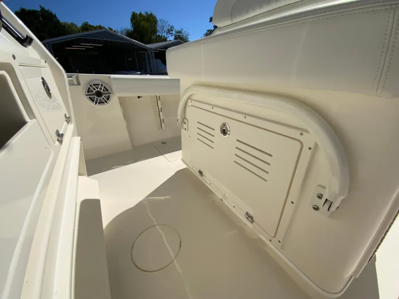 Slide: The Image of 2025 Cobia 240 Center Console boat interior with storage compartment and speaker. - 28