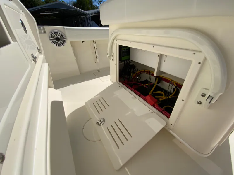 Slide: The Image of 2025 Cobia 240 Center Console boat with open storage compartment. - 29