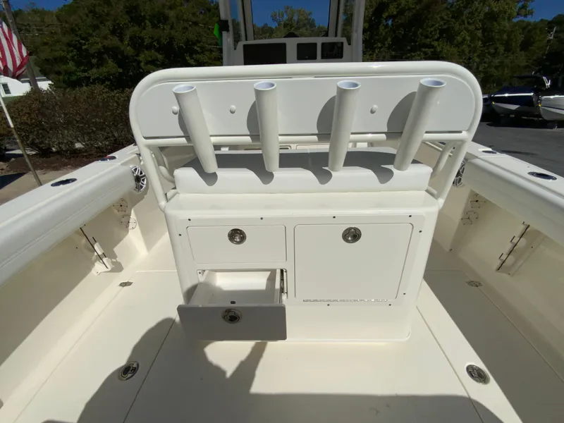 Slide: The Image of 2025 Cobia 240 Center Console boat interior with rod holders and storage compartments. - 32