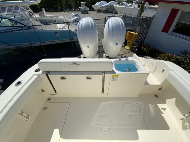 Slide: The Image of 2025 Cobia 240 Center Console boat with dual engines and spacious deck layout. - 38