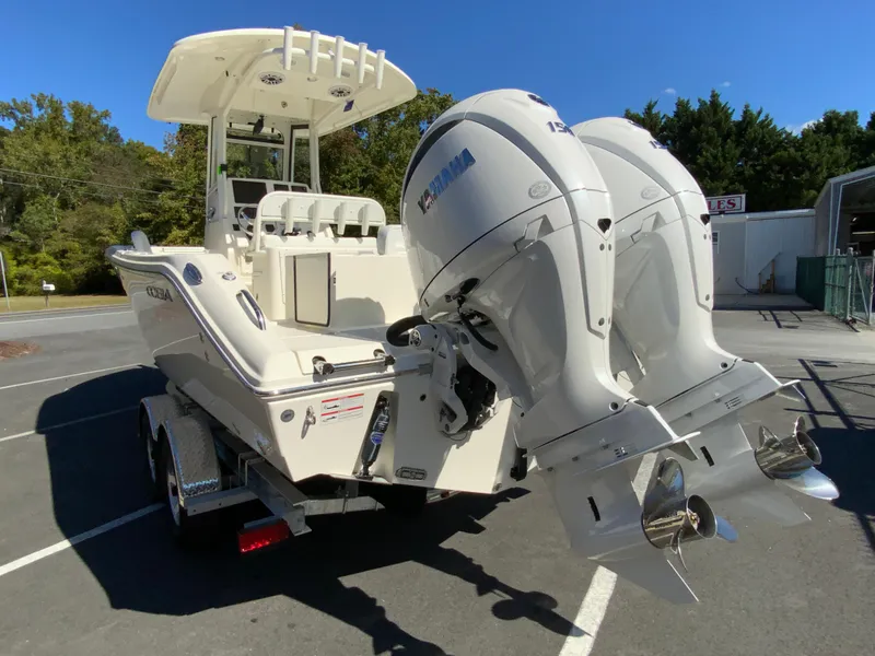 Slide: The Image of 2025 Cobia 240 Center Console boat with dual Yamaha outboard engines on a trailer. - 6