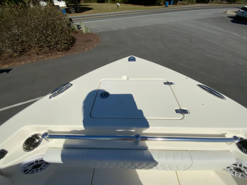 Slide: The Image of 2025 Cobia 240 Center Console boat bow view in a parking lot. - 9
