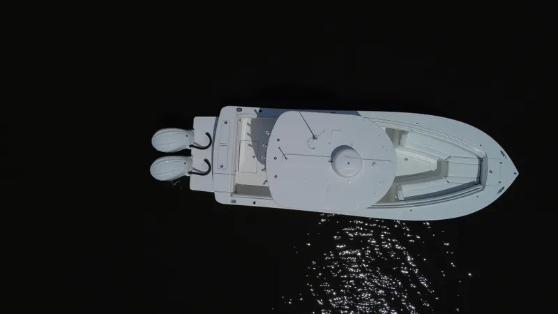 Slide: The Image of Aerial view of 2022 Regulator 25FS boat with twin engines on dark water. - 12