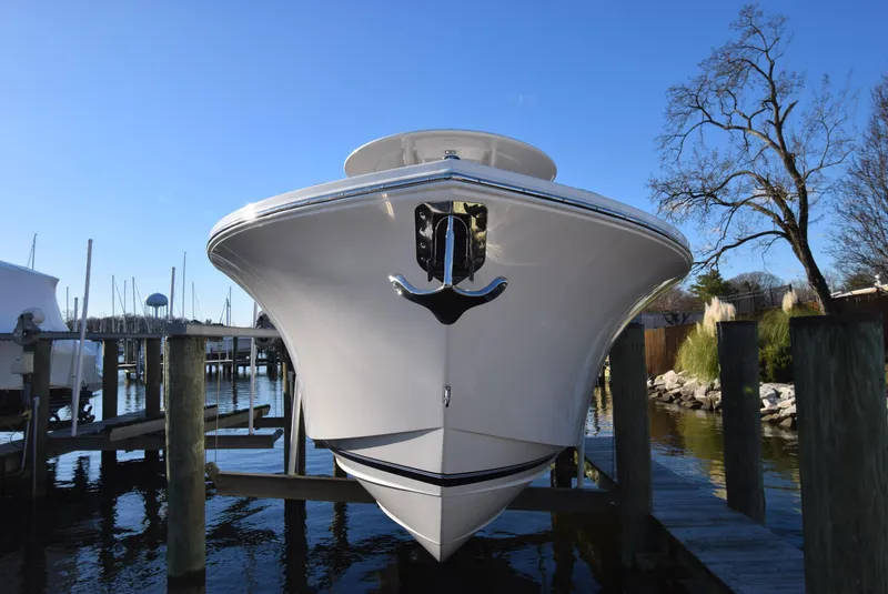 Slide: The Image of 2022 Regulator 25FS boat docked at marina under clear blue sky. - 13