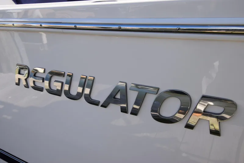 Slide: The Image of Close-up of 2022 Regulator 25FS boat logo on white hull. - 18