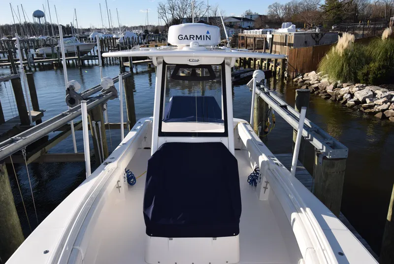Slide: The Image of 2022 Regulator 25FS boat docked at marina with Garmin equipment. - 21