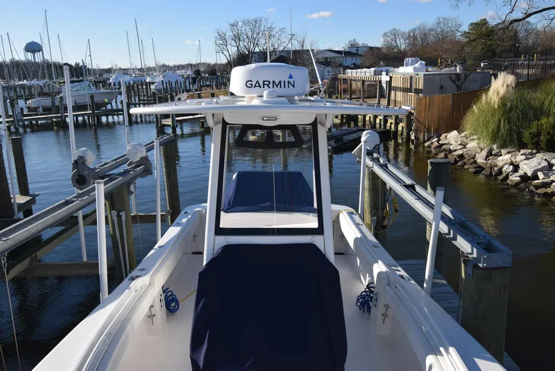 Slide: The Image of 2022 Regulator 25FS boat docked at marina with Garmin equipment. - 22