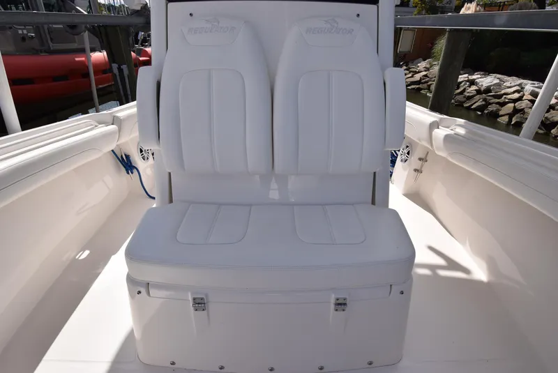 Slide: The Image of 2022 Regulator 25FS boat interior with white cushioned seating. - 24