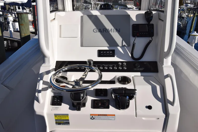 Slide: The Image of 2022 Regulator 25FS boat console with Garmin navigation and steering wheel. - 26
