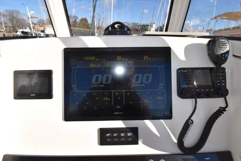 Slide: The Image of 2022 Regulator 25FS boat dashboard with Garmin display and communication equipment. - 27
