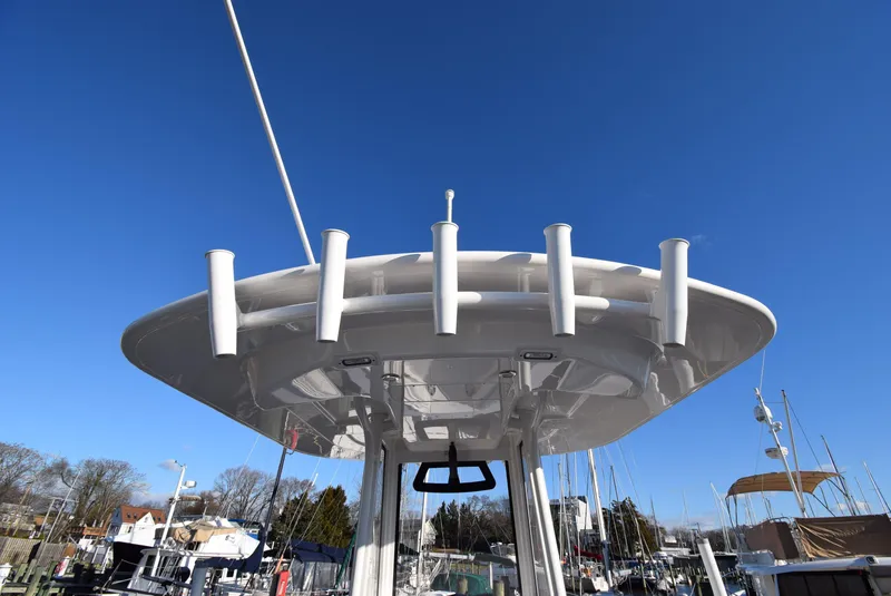 Slide: The Image of 2022 Regulator 25FS boat with rod holders against clear blue sky. - 28