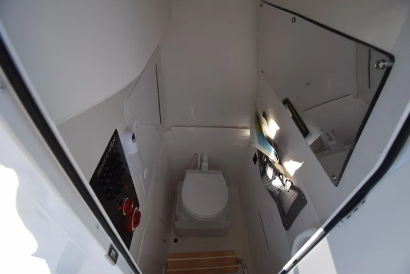 Slide: The Image of 2022 Regulator 25FS boat interior with toilet and storage compartments. - 30