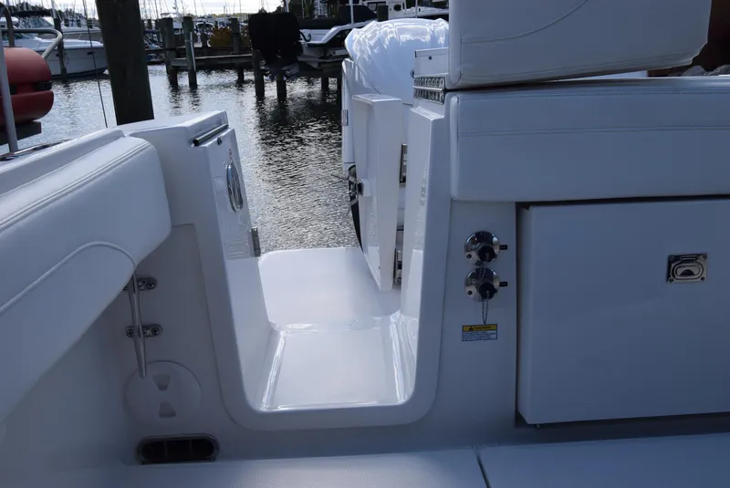 Slide: The Image of 2022 Regulator 25FS boat interior, featuring sleek white seating and storage compartments. - 33