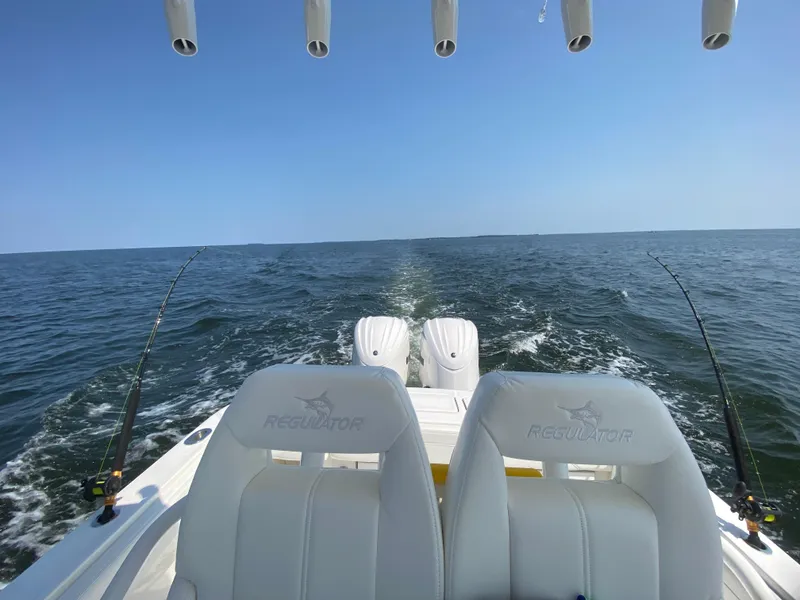 Slide: The Image of 2022 Regulator 25FS boat on open water, fishing rods set up. - 38